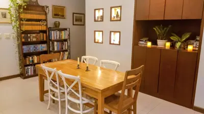 a dining room with a wooden table and chairs at 4-Bedroom cozy pool villa in the heart of Bang Tao in Laguna Phuket