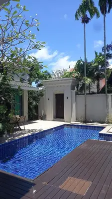 a swimming pool in front of a house at 4-Bedroom cozy pool villa in the heart of Bang Tao in Laguna Phuket