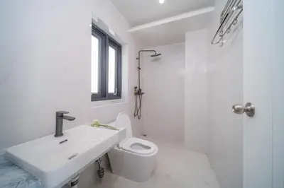 a white bathroom with a sink and a toilet at BangTao 5 Bedrooms 2026 New Modern Private Pool Villa Great Location Close to Bangtao Beach in Ban Thalat Choeng Thale