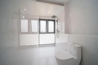 a white bathroom with a toilet and a window at BangTao 5 Bedrooms 2026 New Modern Private Pool Villa Great Location Close to Bangtao Beach in Ban Thalat Choeng Thale
