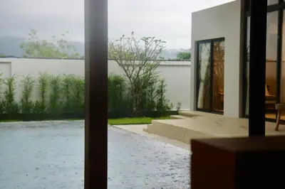 a view of a house from a glass door at Botanica Four Season Luxury Pool Villa in Phuket