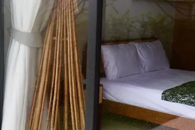 a bedroom with a bed and a window at Botanica Four Season Luxury Pool Villa in Phuket