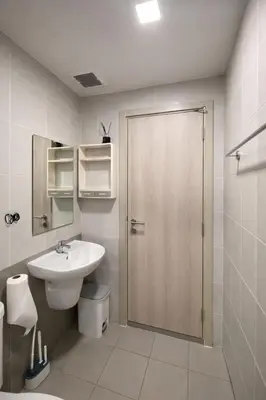 a bathroom with a sink and a shower with a door at Modern Apartment with Pool & Gym in Kathu