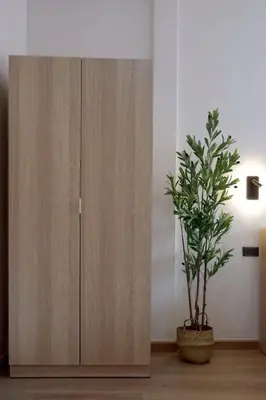 a wooden cabinet with a potted plant next to it at Tree House in Ban Rangeng