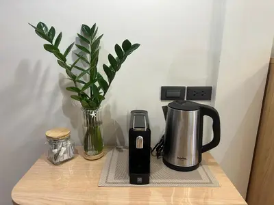 a coffeemaker and a coffee maker on a table at Tree House in Ban Rangeng