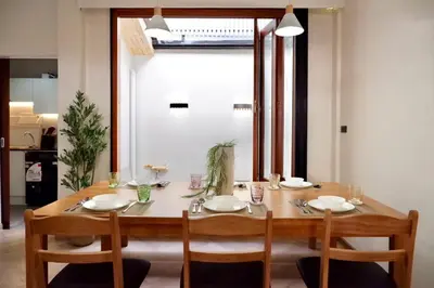 a dining room table with four chairs around it at Tree House in Ban Rangeng