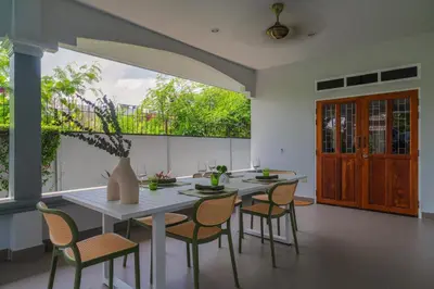 a dining room with a table and chairs at Greenleaf Estate - 3bedroom Villa with large shared pool, Nai harn beach in Rawai Beach