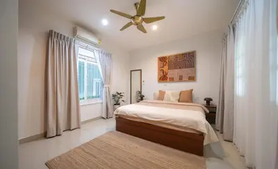 a bedroom with a bed and a ceiling fan at Greenleaf Estate - 3bedroom Villa with large shared pool, Nai harn beach in Rawai Beach