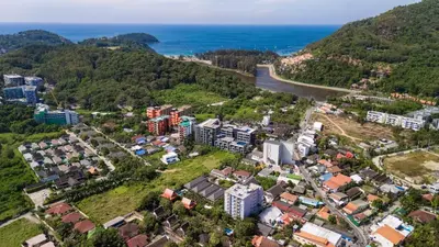 an aerial view of a city with houses and the ocean at Greenleaf Estate - 3bedroom Villa with large shared pool, Nai harn beach in Rawai Beach
