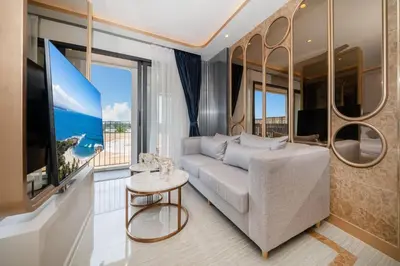a living room with a couch and a large window at Apartment in Laguna perfect location in Laguna Phuket