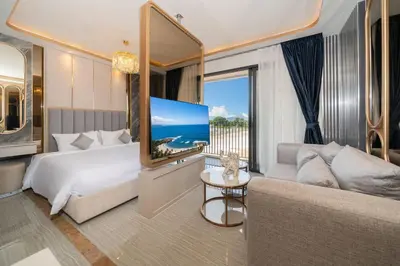 a bedroom with a bed and a couch and a tv at Apartment in Laguna perfect location in Laguna Phuket