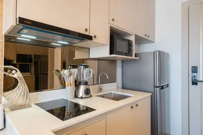 a kitchen with a sink and a refrigerator at Apartment in Laguna perfect location in Laguna Phuket
