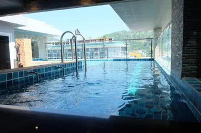 a large swimming pool in a building at Bauman Residence in Patong Beach