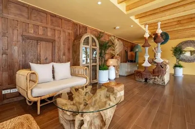 a living room with wooden walls and a glass table at Chaykha Retreat