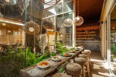 a restaurant with a long table with bowls of food at Chaykha Retreat