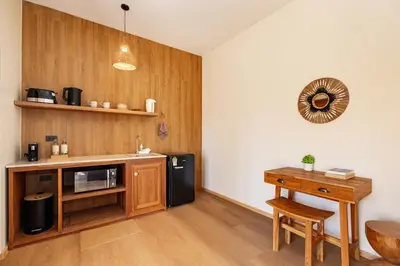 a kitchen with a counter and a microwave and a table at Chaykha Retreat