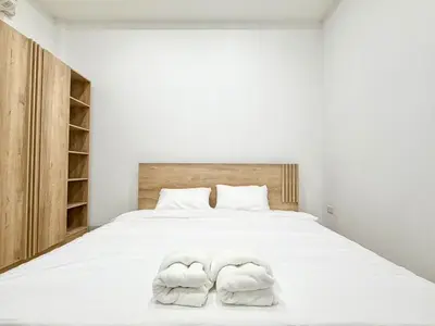 a bedroom with a white bed with towels on it at Home in Chalong 3 Bedrooms Fully Furnished in Ban Suan
