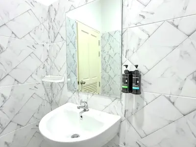a white bathroom with a sink and a mirror at Home in Chalong 3 Bedrooms Fully Furnished in Ban Suan
