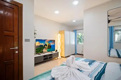a bedroom with a bed with a towel on it at Kata Seaview Villa in Ban Karon