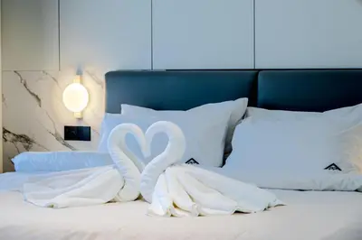 two swansrendered to look like swans on a bed at KORA 243 One-Bedroom Residence in Phuket Town