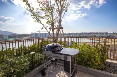 a grill on a balcony with a tree on it at Canvas 11112 Cozy 2BR Residence in Phuket Town
