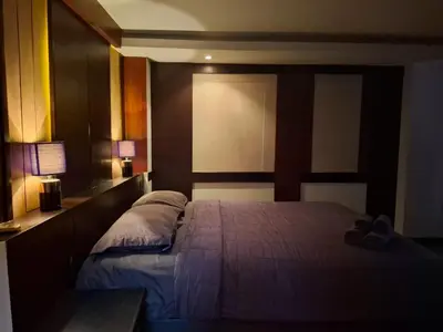 a bedroom with a bed with two pillows on it at Arizona Residence in Ban Ko En
