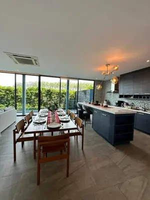 a kitchen and dining room with a table and chairs at Bangtao Family Villa with Pool in Ban Pak Lak
