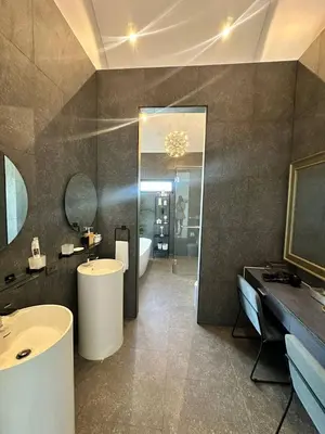 a bathroom with two sinks and a tub and a mirror at Bangtao Family Villa with Pool in Ban Pak Lak