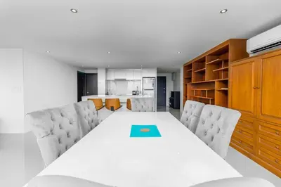 a dining room with a white table and chairs at C265 Great Ocean View 2BR Pool & Gym Near Beach in Patong Beach