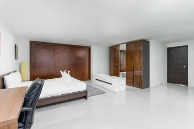 a bedroom with a bed and a desk at C265 Great Ocean View 2BR Pool & Gym Near Beach in Patong Beach