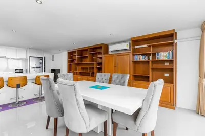 a dining room with a white table and chairs at C265 Great Ocean View 2BR Pool & Gym Near Beach in Patong Beach