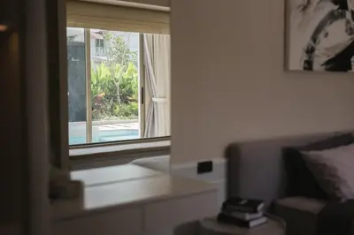 a living room with a window and a couch at Pool Villa Rawai, Phuket Lay Pearl in Ban Saiyuan (1)
