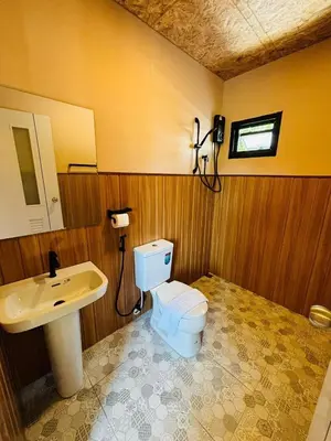 a bathroom with a toilet and a sink at Tavana Residence in Ban Na Bon