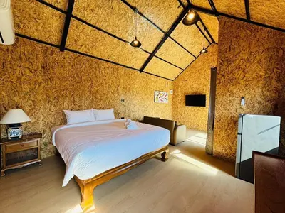 a bedroom with a bed in a brick wall at Tavana Residence in Ban Na Bon