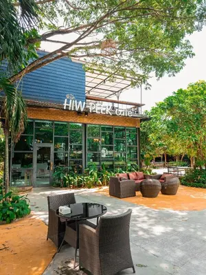 a building with a table and chairs in front of it at Tavana Residence in Ban Na Bon