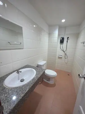 a bathroom with a sink and a toilet at Chokdee rooms kata in Kata Beach