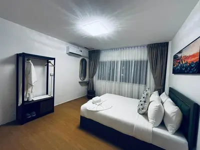 a bedroom with a large bed and a mirror at Phuket gateway inn in Kathu