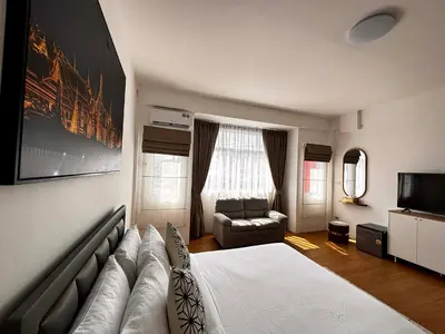 a living room with a large bed and a couch at Phuket gateway inn in Kathu