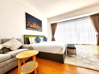 a hotel room with a bed and a couch at Phuket gateway inn in Kathu