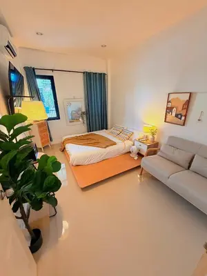 a bedroom with a bed and a couch at Phuket sun n soul House in Ban Tha Rua