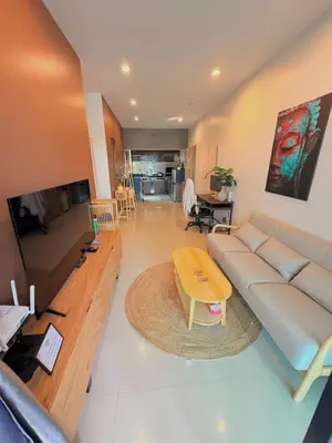 a living room with a large couch and a table at Phuket sun n soul House in Ban Tha Rua