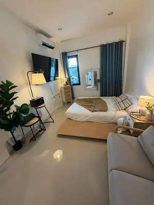 a bedroom with a bed and a living room at Phuket sun n soul House in Ban Tha Rua