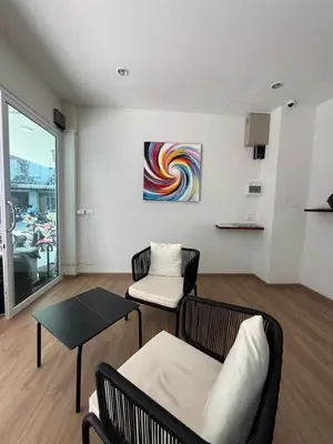a living room with a couch and a table at Top Hotel Patong in Patong Beach