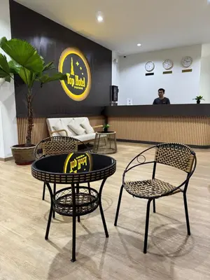 a room with two chairs and a table and a counter at Top Hotel Patong in Patong Beach