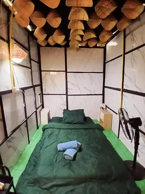 a room with a green bed in a room at Kalaland in Patong Beach