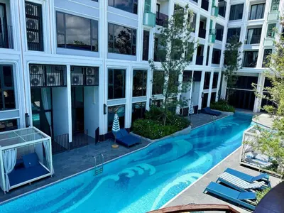 an external view of a building with a swimming pool at Stylish Apartments in a New Boutique Complex in the Laguna in Laguna Phuket