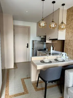 a kitchen with a white island in a room at Stylish Apartments in a New Boutique Complex in the Laguna in Laguna Phuket