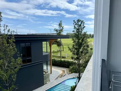 a view from the balcony of a house with a swimming pool at Stylish Apartments in a New Boutique Complex in the Laguna in Laguna Phuket