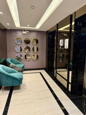 a dressing room with a blue chair and a mirror at Stylish Apartments in a New Boutique Complex in the Laguna in Laguna Phuket