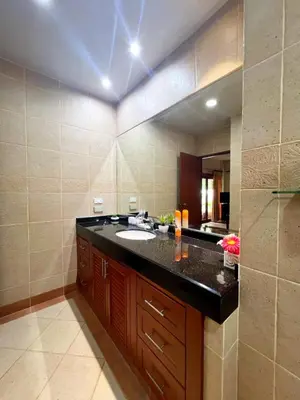 a bathroom with a sink and a large mirror at Luxury 3-bedroom villa with pool in Rawai in Rawai Beach
